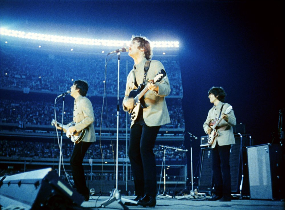 Large open-air stadium filled with fans at a night concert
